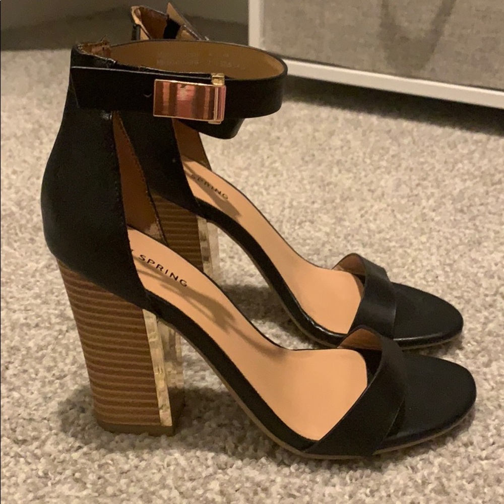 Black sandals with wood heels and gold buckles